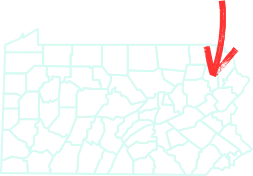 This image shows a map of Pennsylvania divided into its counties, with a bold red arrow pointing toward Lackawanna County in the northeastern part of the state. This highlights the area where Scranton is located, a key cultural and population center in the region.